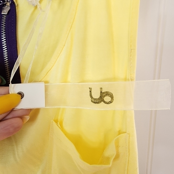 Ya sleeveless yellow top with bold multi colored bottom in a floral pattern. - Picture 6 of 9